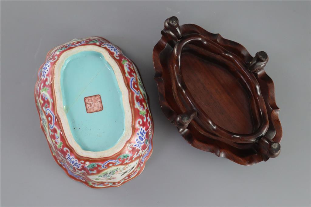 A Chinese ruby ground jardiniere, Daoguang mark and of the period (1821-50), 17cm wide, 6.5cm high, wood stand